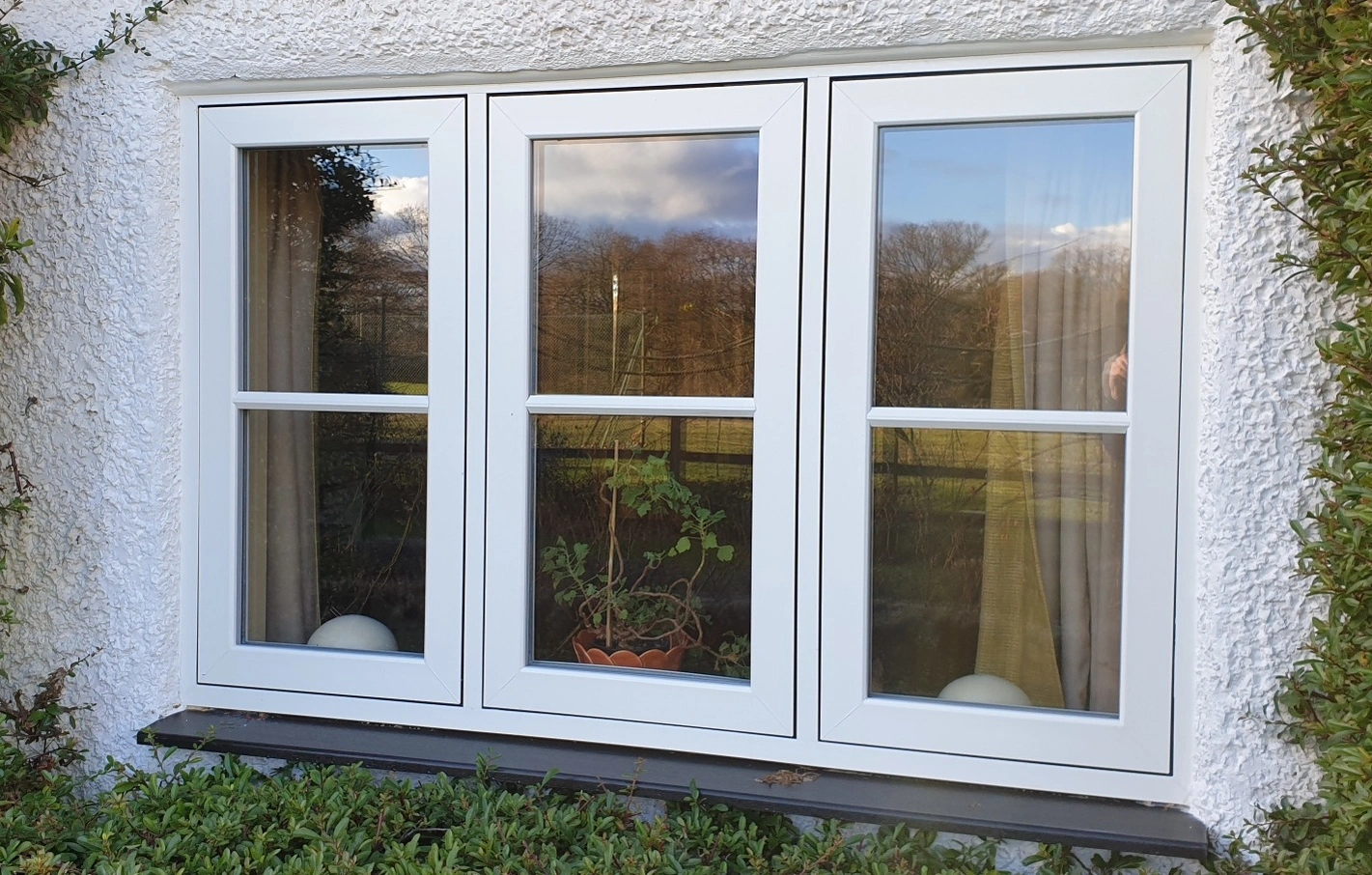 white flush fit window in white rendered wall with authentic gerogian bar