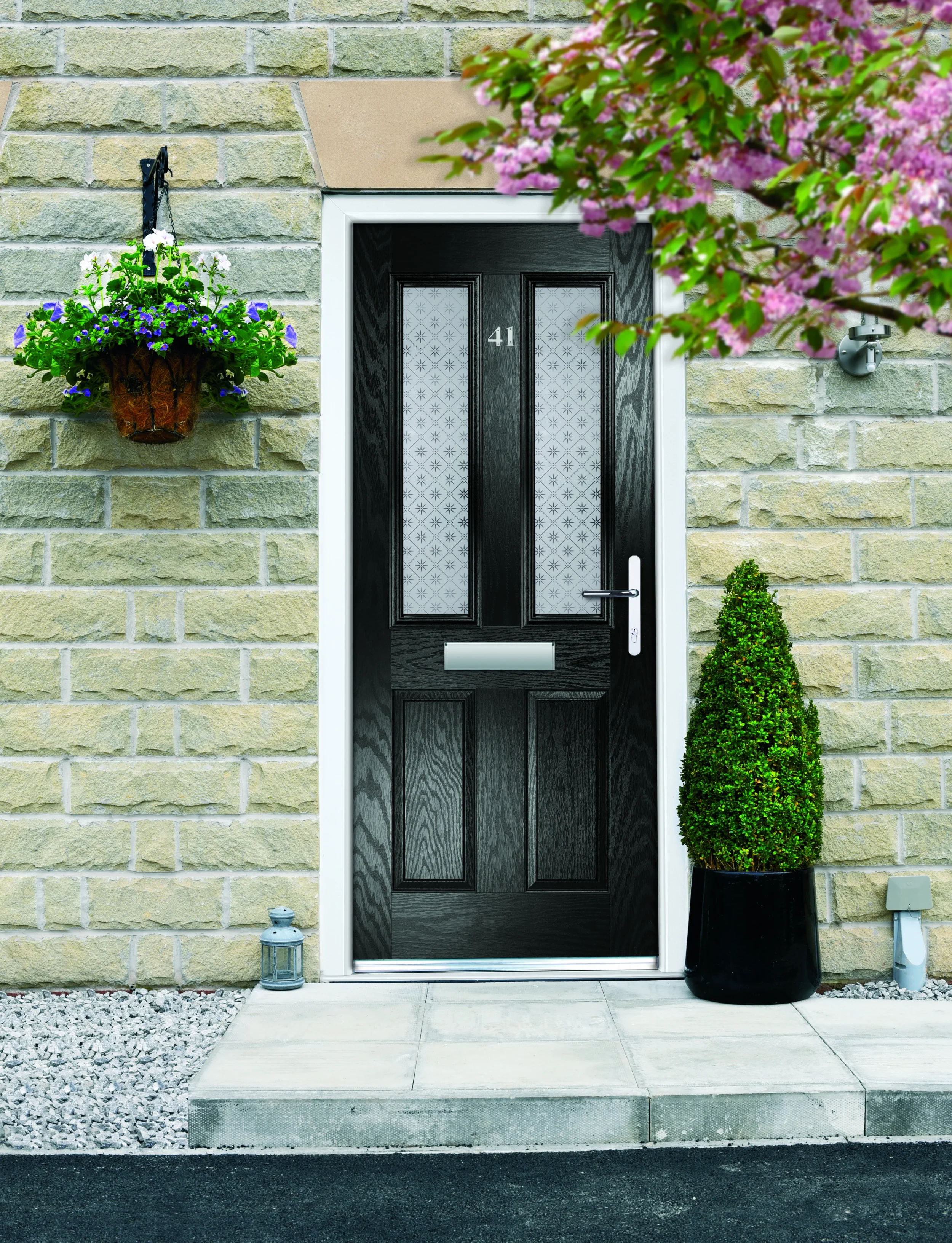 black composite door and a half in rendered wall