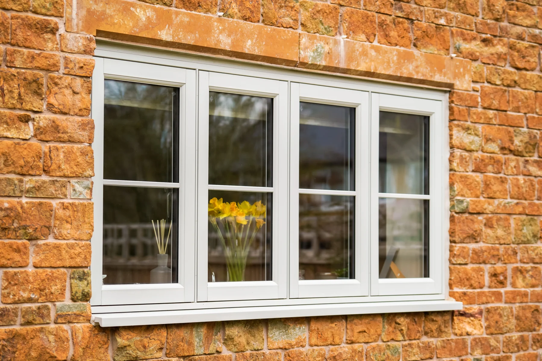 white amazon flush fit window with georgian bar in brick wall