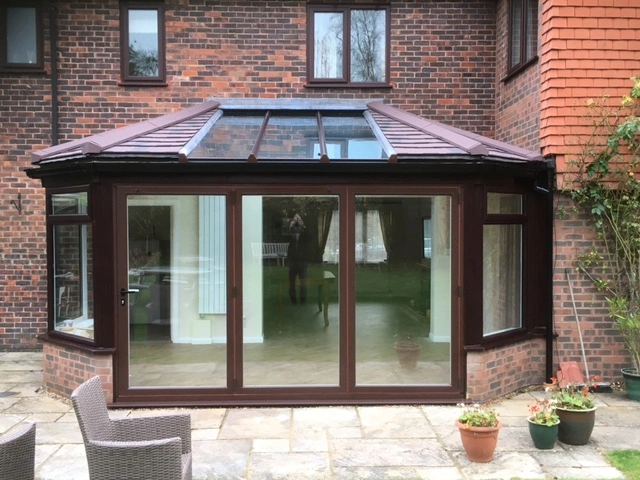 woodgrain guardian solid roof with bifold doors