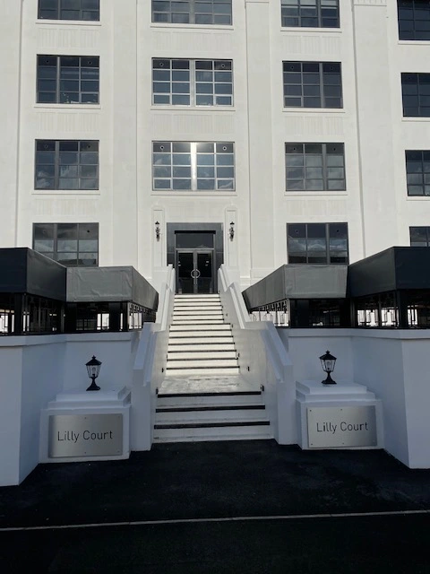 black aluminium windows and entrance door in white building