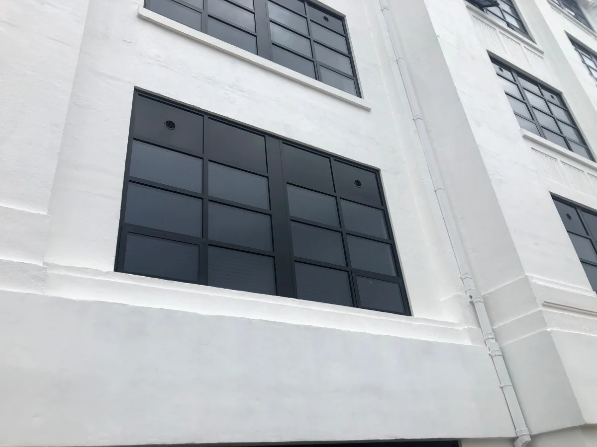 black aluminium window close up in white painted building