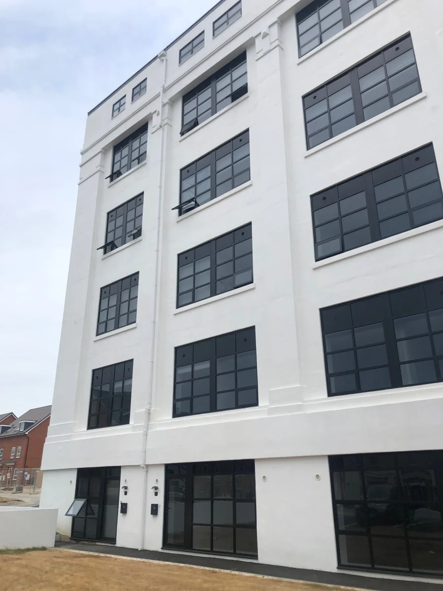 blck aluminium window in white rendered building